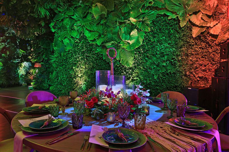 Tablescape with background of rainforest decorated walls.