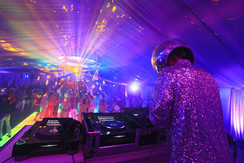 The coolest DJ at the turntable with a glittering suit and disco mirror ball for a head!